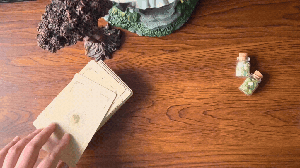 A person drawing a single tarot card.